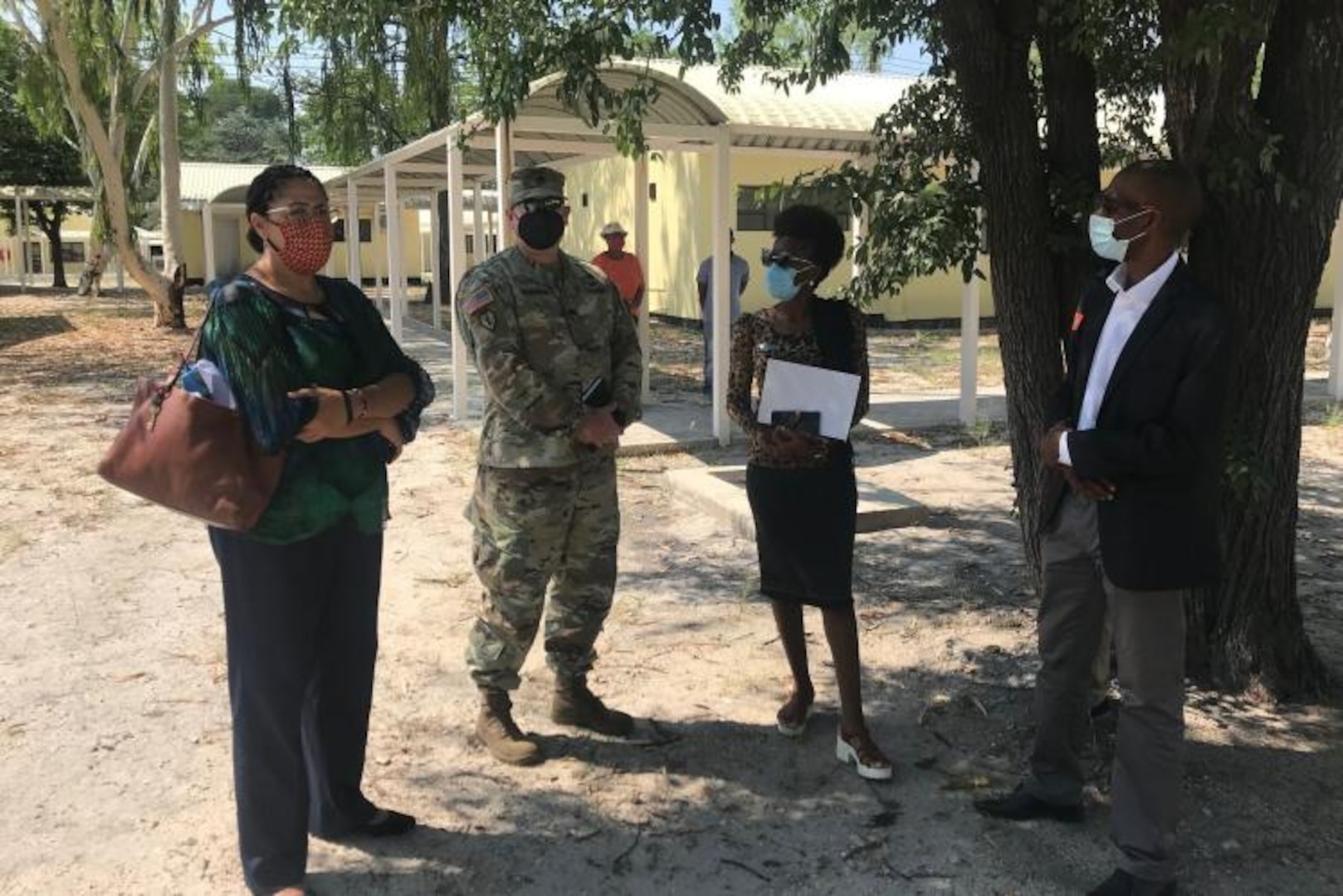 members stand in front of COVID-19 isolation clinics