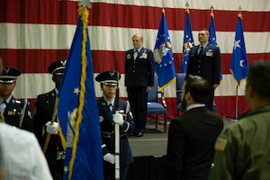 a military honor guard detail presents the colors during a military ceremony.