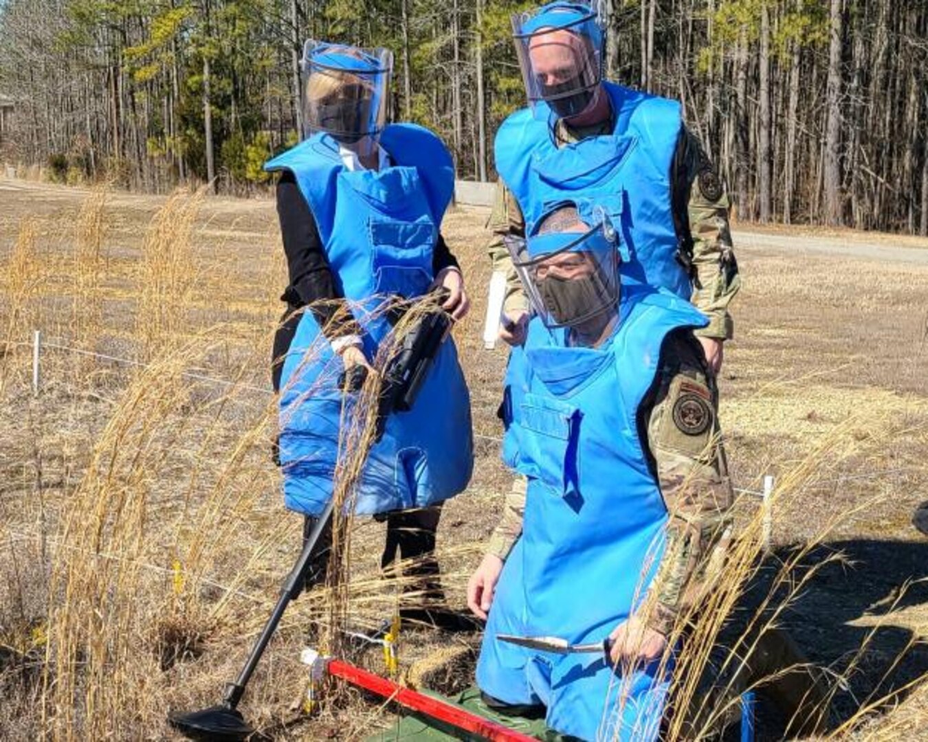 Director Heidi Grant, CMSgt Daniel Simpson, and Col Malcolm Pharr prepare for a landmine clearance drill in deminers Personal Protective Equipment.