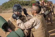 U.S. Marine Corps recruits with Fox Company, 2nd Recruit Training Battalion, put on safety gear before executing pugil sticks during the Crucible at Marine Corps Base Camp Pendleton, California, Dec. 3, 2024. The Crucible is a 54-hour exercise where recruits apply the knowledge they learned throughout recruit training to earn the title United States Marine. (U.S. Marine Corps photo by Lance Cpl. Jacob B. Hutchinson)