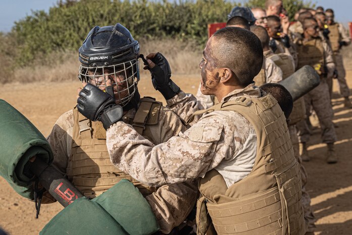 U.S. Marine Corps recruits with Fox Company, 2nd Recruit Training Battalion, put on safety gear before executing pugil sticks during the Crucible at Marine Corps Base Camp Pendleton, California, Dec. 3, 2024. The Crucible is a 54-hour exercise where recruits apply the knowledge they learned throughout recruit training to earn the title United States Marine. (U.S. Marine Corps photo by Lance Cpl. Jacob B. Hutchinson)