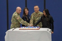 Maj. Gen. Michel Natali, New York assistant adjutant general, and Airman Gabriel Geise, 18, Master Sgt. Michel Schin, 59, and Pvt. 1st Class Aliyah Billar, 17, mark the 388th anniversary of the National Guard's birthday Dec. 13, 2024, at New York National Guard headquarters in Latham.
