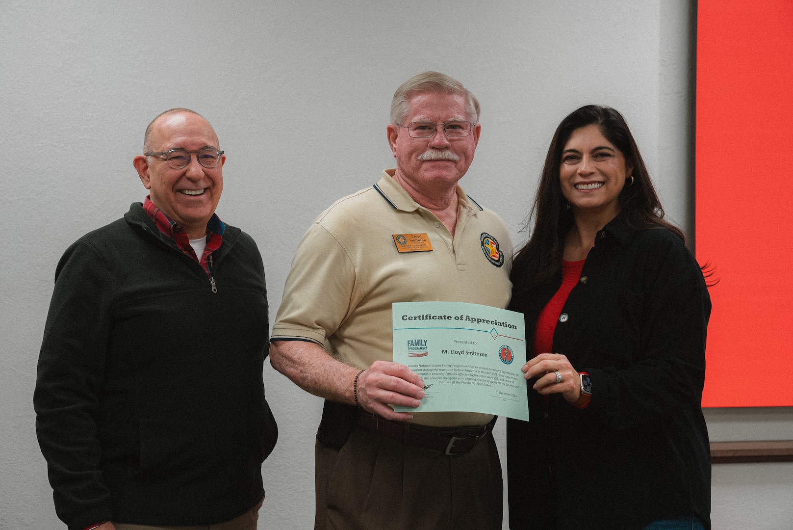 Warren Griffis (left), Lloyd Smithson (middle), both members of the Oklahoma National Guard Family Program Office, stand with Col. Yolanda Murray (right), director of manpower and personnel for the OKNG, after being presented certificates of appreciation from the Florida National Guard Family Program Office for providing remote relief to more than 750 FLNG Soldiers affected by Hurricane Helene by offering resource referral assistance. The support lessened the burden of the Florida National Guard while enabling their Guardsmen to focus on responding to the devastation. (Oklahoma National Guard photo by Staff Sgt. Reece Heck)