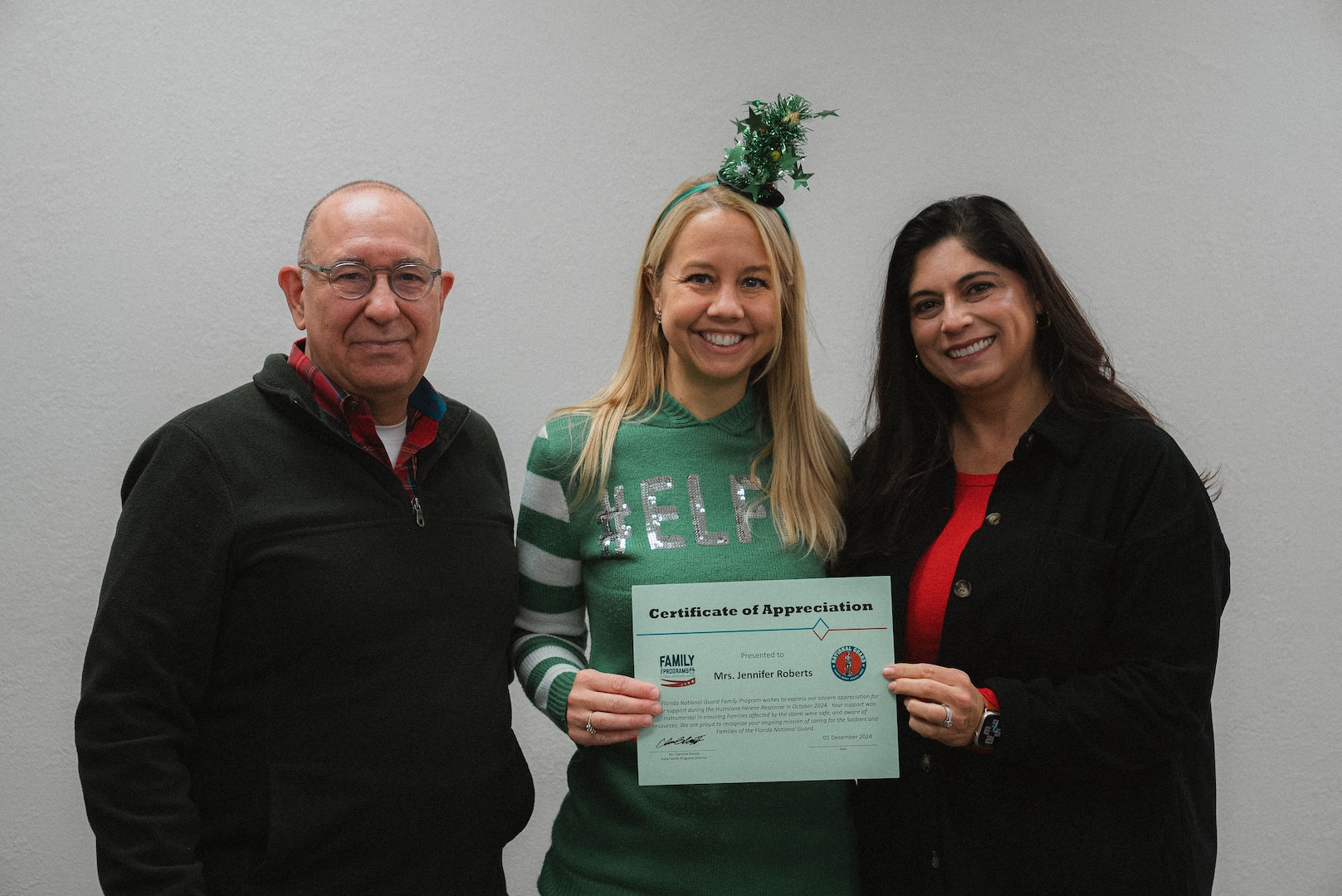 Warren Griffis (left), Jennifer Roberts (middle), both members of the Oklahoma National Guard Family Program Office, stand with Col. Yolanda Murray (right), director of manpower and personnel for the OKNG, after being presented certificates of appreciation from the Florida National Guard Family Program Office for providing remote relief to more than 750 FLNG Soldiers affected by Hurricane Helene by offering resource referral assistance. The support lessened the burden of the Florida National Guard while enabling their Guardsmen to focus on responding to the devastation. (Oklahoma National Guard photo by Staff Sgt. Reece Heck)