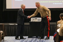 U.S. Marine Corps Gen. Charles Krulak, 31st Commandant of the Marine Corps, retired, left, shakes hands with Maj. Gen. William Bowers, Marine Corps Recruiting Command commanding general, right, during the Fiscal Year 2025 National Officer Selection Officer Training Symposium in Orlando on Dec. 10, 2024. NOSOTS is designed to conduct training, discuss recruiting topics and issues and recognize those Officer Selection Teams which have distinguished themselves during the previous fiscal year. (U.S. Marine Corps photo by Lance Cpl. Brenna Ritchie)