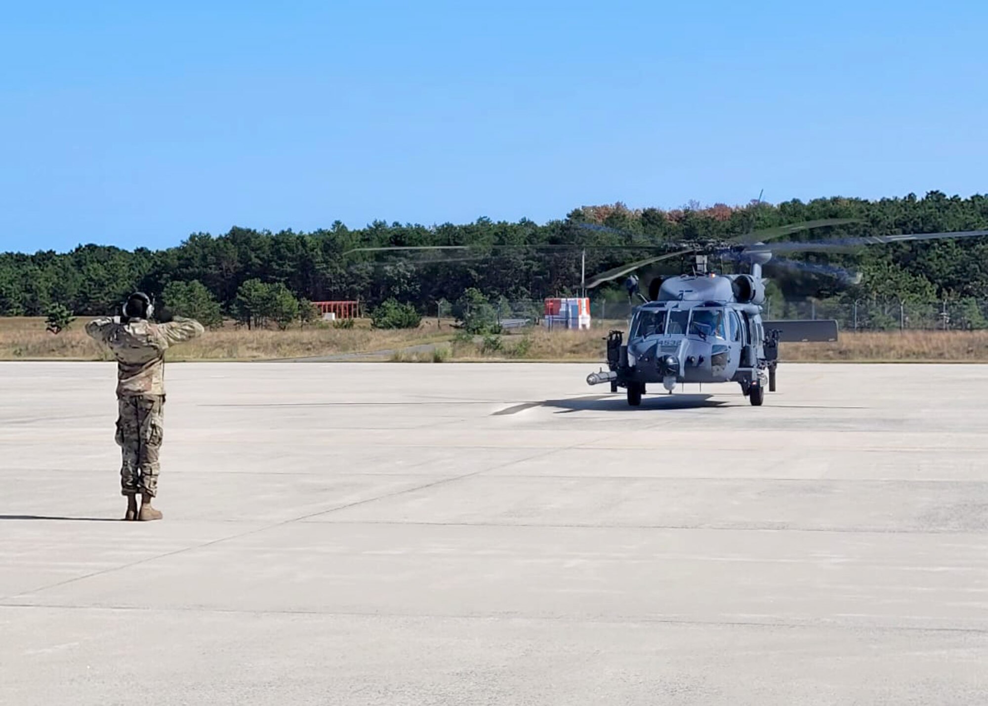 A New York Air National Guard Airman from the 106th Rescue Wing marshals the newly arrived HH-60W Jolly Green II search and rescue helicopter at Francis S. Gabreski Air National Guard Base, Westhampton Beach, N.Y., Sept. 12, 2024.