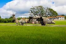 U.S. Navy corpsmen with Bravo Surgical Company, 3d Medical Battalion, load a simulated casualty onto a U.S. Army UH-60Q Black Hawk during joint casualty evacuation (CASEVAC) and hoist training, Joint Base Pearl Harbor-Hickam, Hawaii, Nov. 20, 2024. 3d Med Bn provided health service support in joint operations and increased interoperability with U.S. Army MEDEVAC platforms and transportation companies. (U.S. Marine Corps photo by Lance Cpl. Marcos AlbertoRocha)