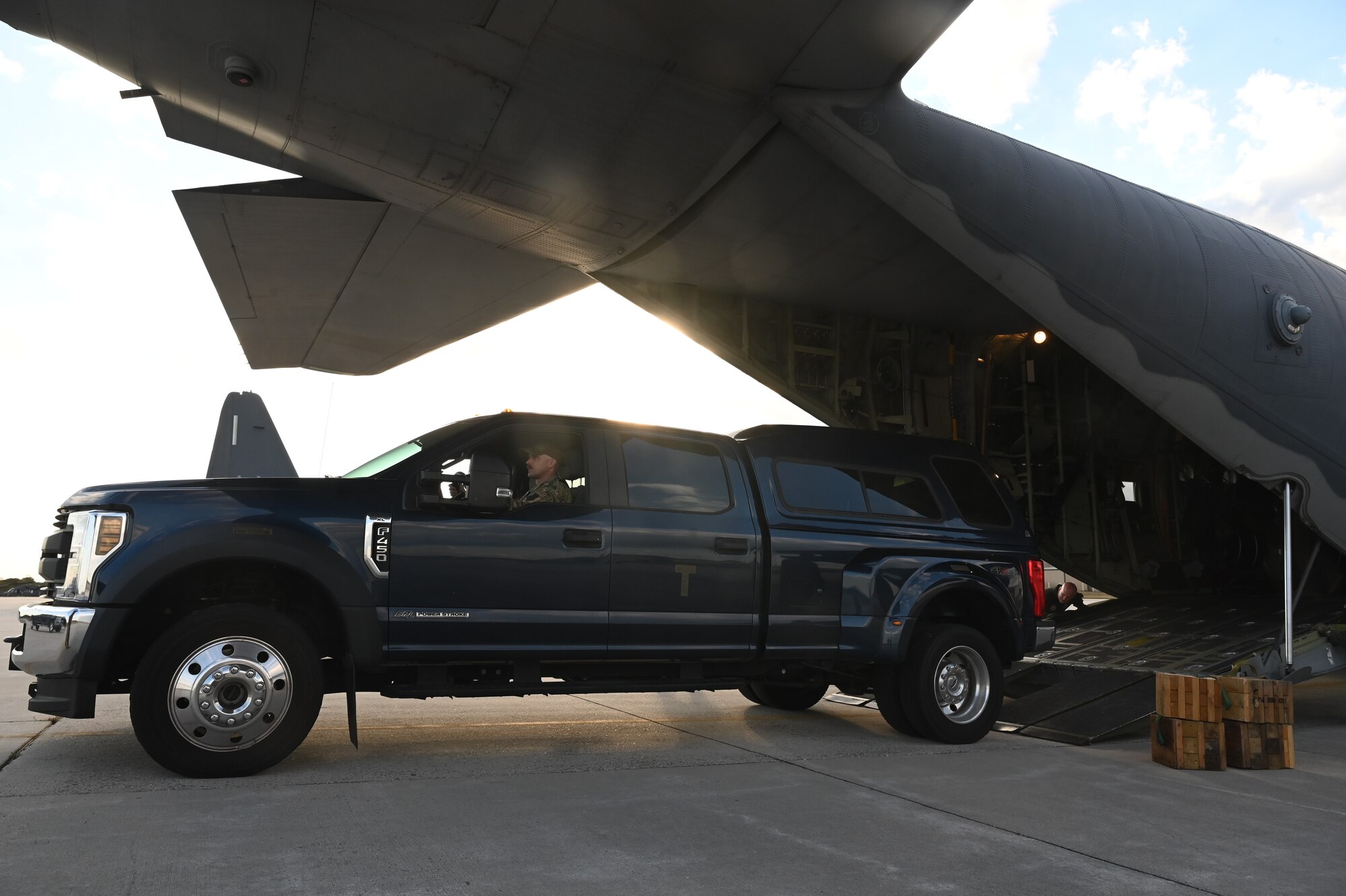 102nd Rescue Squadron loadmasters, assigned to the 106th Rescue Wing, load a stake-bed truck aboard an HC-130J Combat King II search and rescue aircraft for Hurricane Milton support at Francis S. Gabreski Air National Guard base, Westhampton Beach, N.Y., October 9, 2024.