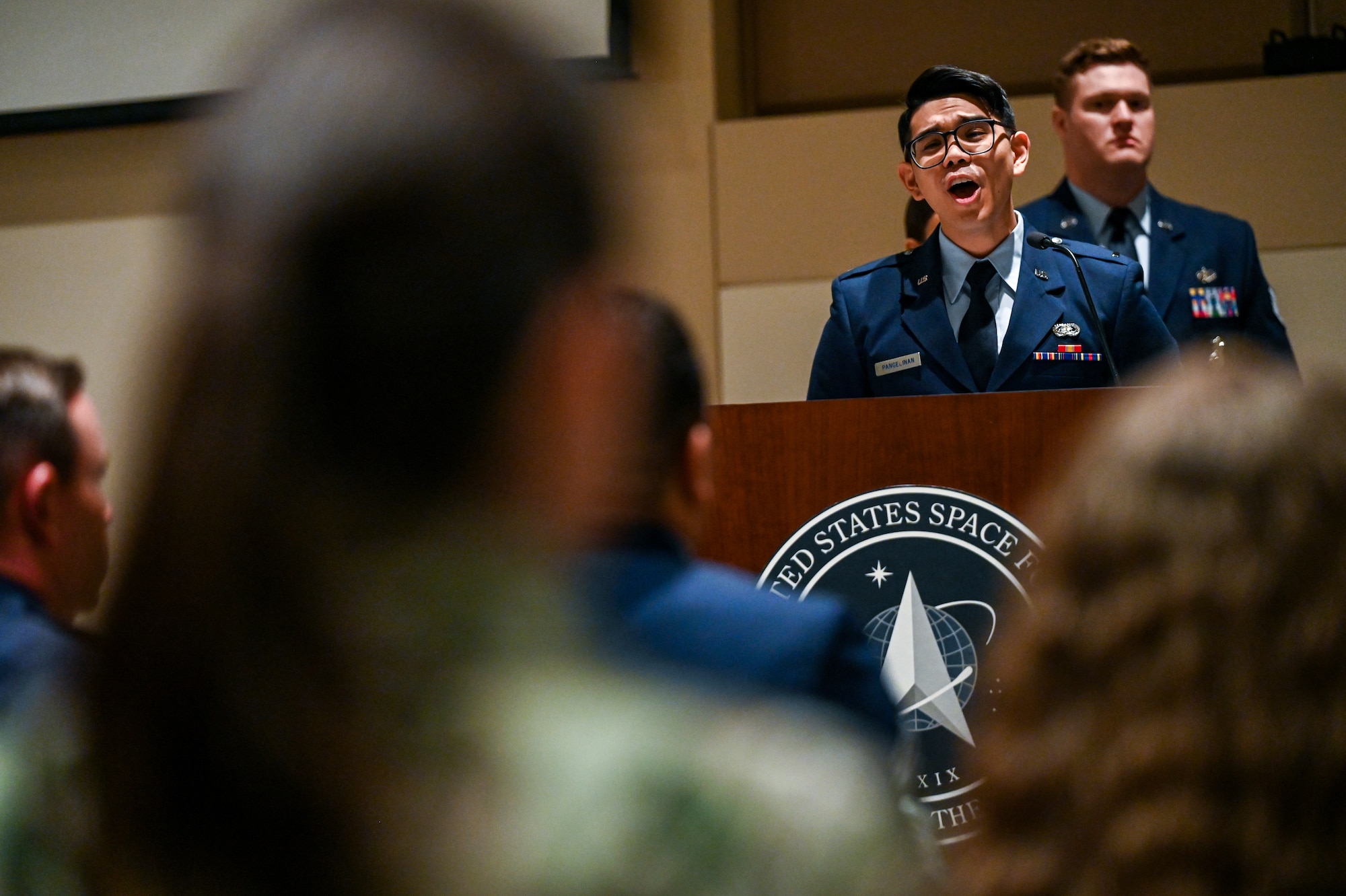 man in air force uniform sings national anthem