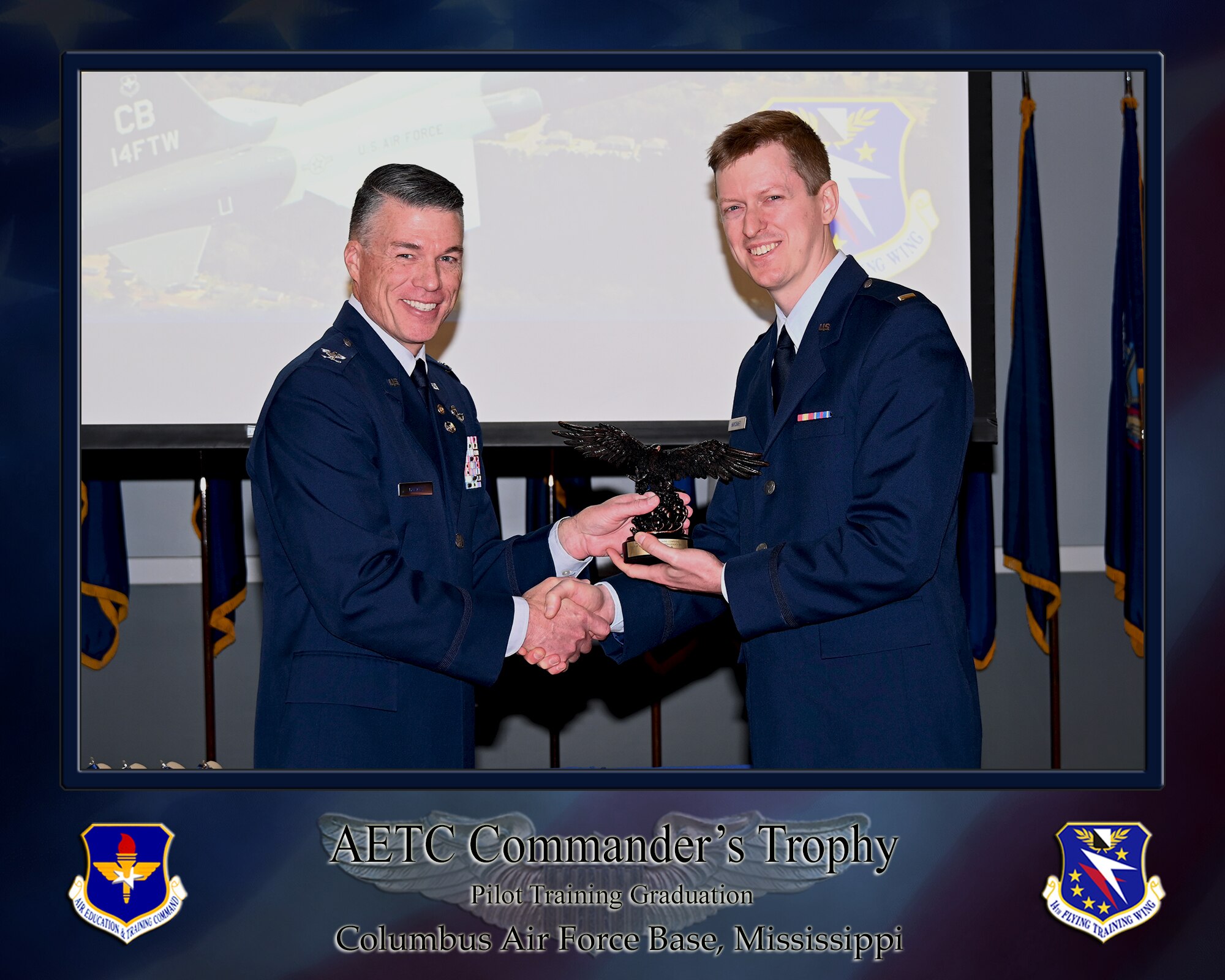 Undergraduate Pilot Training Class 25-03 graduation speaker Colonel (Ret) Douglas C. Gosney and 2nd LT Jesse D. Haycraft, pose for a photo with the Air Education and Training Command commander’s trophy during the official graduation ceremony on December 13, 2024, at the Columbus Events Center on Columbus Air Force Base, Mississippi. Haycraft was also recognized as the Distinguished Graduate, receiving the Distinguished Graduate Award. (U.S. Air Force photo by Melissa Duncan-Doublin)