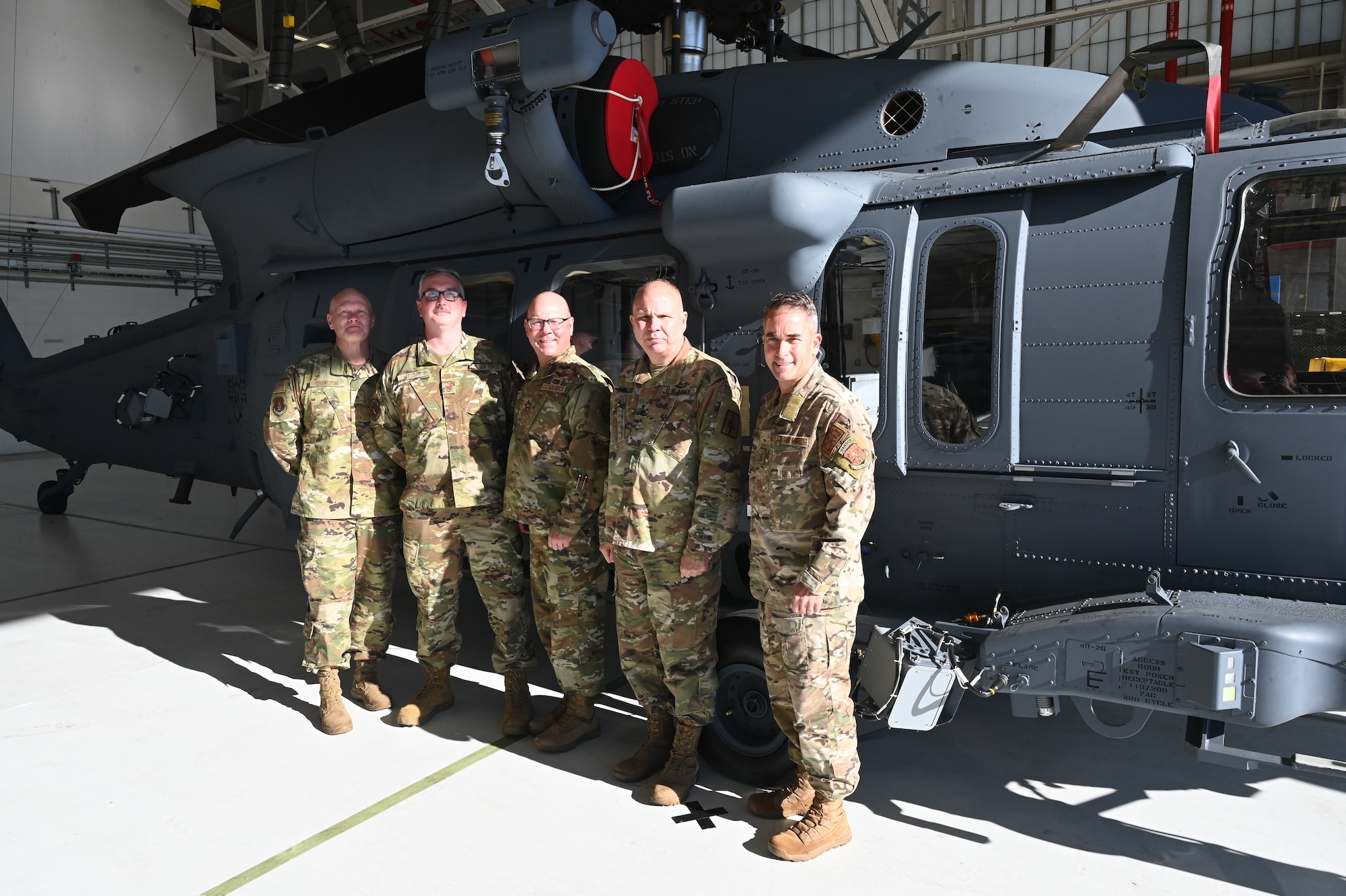 Leaders from the New York Air National Guard, congratulate Tech. Sgt. Michael Tessar, an HH-60W crew chief assigned to the 106th Rescue Wing, during an HH-60W conversion ceremony at the 106th Rescue Wing based at Francis S. Gabreski Air National Guard Base, Westhampton Beach, N.Y., October 25, 2024.
