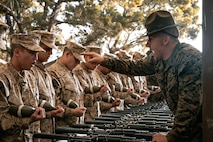U.S. Marine Corps Drill Instructor, Sgt. Nicholas Marsh, with India Company, 3rd Recruit Training Battalion, instructs recruits before for a M16A4 service rifle issue at Marine Corps Recruit Depot San Diego, California, Dec. 9, 2024. Recruits will carry their rifles throughout recruit training and will learn how to properly clean and maintain them to help extend the life of the rifles for future recruits. Marines are warfighters first, and always. Every Marine is a rifleman, and Marine officer is a rifle platoon commander. This unique characteristic distinguishes Marines from all Services, at home and abroad. (U.S. Marine Corps photo by Cpl. Sarah M. Grawcock)