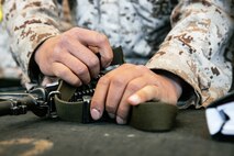 U.S. Marine Corps recruit with India Company, 3rd Recruit Training Battalion, puts a sling on their rifle during a M16A4 service rifle issue at Marine Corps Recruit Depot San Diego, California, Dec. 9, 2024. Recruits will carry their rifles throughout recruit training and will learn how to properly clean and maintain them to help extend the life of the rifles for future recruits. Marines are warfighters first, and always. Every Marine is a rifleman, and Marine officer is a rifle platoon commander. This unique characteristic distinguishes Marines from all Services, at home and abroad. (U.S. Marine Corps photo by Cpl. Sarah M. Grawcock)