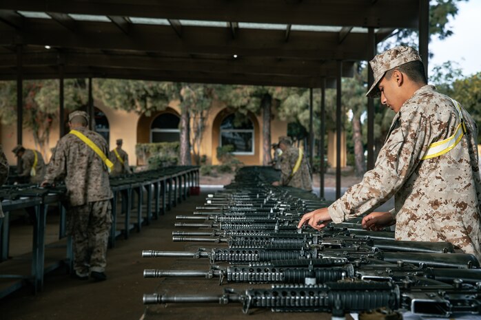U.S. Marine Corps recruits with India Company, 3rd Recruit Training Battalion, set up rifles for a M16A4 service rifle issue at Marine Corps Recruit Depot San Diego, California, Dec. 9, 2024. Recruits will carry their rifles throughout recruit training and will learn how to properly clean and maintain them to help extend the life of the rifles for future recruits. Marines are warfighters first, and always. Every Marine is a rifleman, and Marine officer is a rifle platoon commander. This unique characteristic distinguishes Marines from all Services, at home and abroad. (U.S. Marine Corps photo by Cpl. Sarah M. Grawcock)