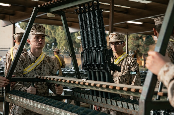 U.S. Marine Corps recruits with India Company, 3rd Recruit Training Battalion, set up rifles for a M16A4 service rifle issue at Marine Corps Recruit Depot San Diego, California, Dec. 9, 2024. Recruits will carry their rifles throughout recruit training and will learn how to properly clean and maintain them to help extend the life of the rifles for future recruits. Marines are warfighters first, and always. Every Marine is a rifleman, and Marine officer is a rifle platoon commander. This unique characteristic distinguishes Marines from all Services, at home and abroad. (U.S. Marine Corps photo by Cpl. Sarah M. Grawcock)