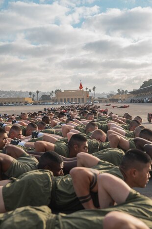 New U.S. Marines with Charlie Company, 1st Recruit Training Battalion, conduct dynamic warm-ups prior to the company motivational run at Marine Corps Recruit Depot San Diego, California, Dec. 12, 2024. The company motivational run is a three-mile cadence run conducted around the Depot, the last physical training event the Marines will conduct before they graduate from MCRD San Diego and the first time their friends and families will see their newly transformed U.S. Marines. (U.S. Marine Corps photo by Cpl. Alexandra M. Earl)