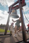 A new U.S. Marine with Charlie Company, 1st Recruit Training Battalion, rings the liberty bell during the company motivational run at Marine Corps Recruit Depot San Diego, California, Dec. 12, 2024. The company motivational run is a three-mile cadence run conducted around the Depot, the last physical training event the Marines will conduct before they graduate from MCRD San Diego and the first time their friends and families will see their newly transformed U.S. Marines. (U.S. Marine Corps photo by Cpl. Alexandra M. Earl)