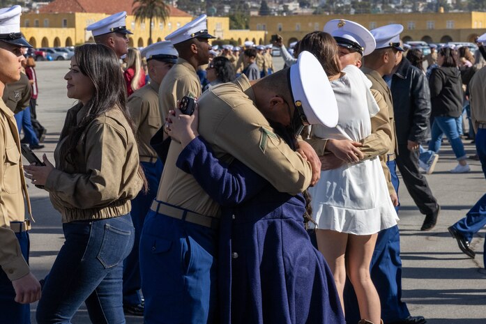 A new U.S. Marine with Charlie Company, 1st Recruit Training Battalion, is greeted by his guest following his graduation ceremony at Marine Corps Recruit Depot San Diego, California, Dec. 13, 2024. Graduation took place at the completion of the 13-week transformation, which included training for drill, marksmanship, basic combat skills, and Marine Corps customs and traditions. (U.S. Marine Corps photo by Lance Cpl. Jacob B. Hutchinson)