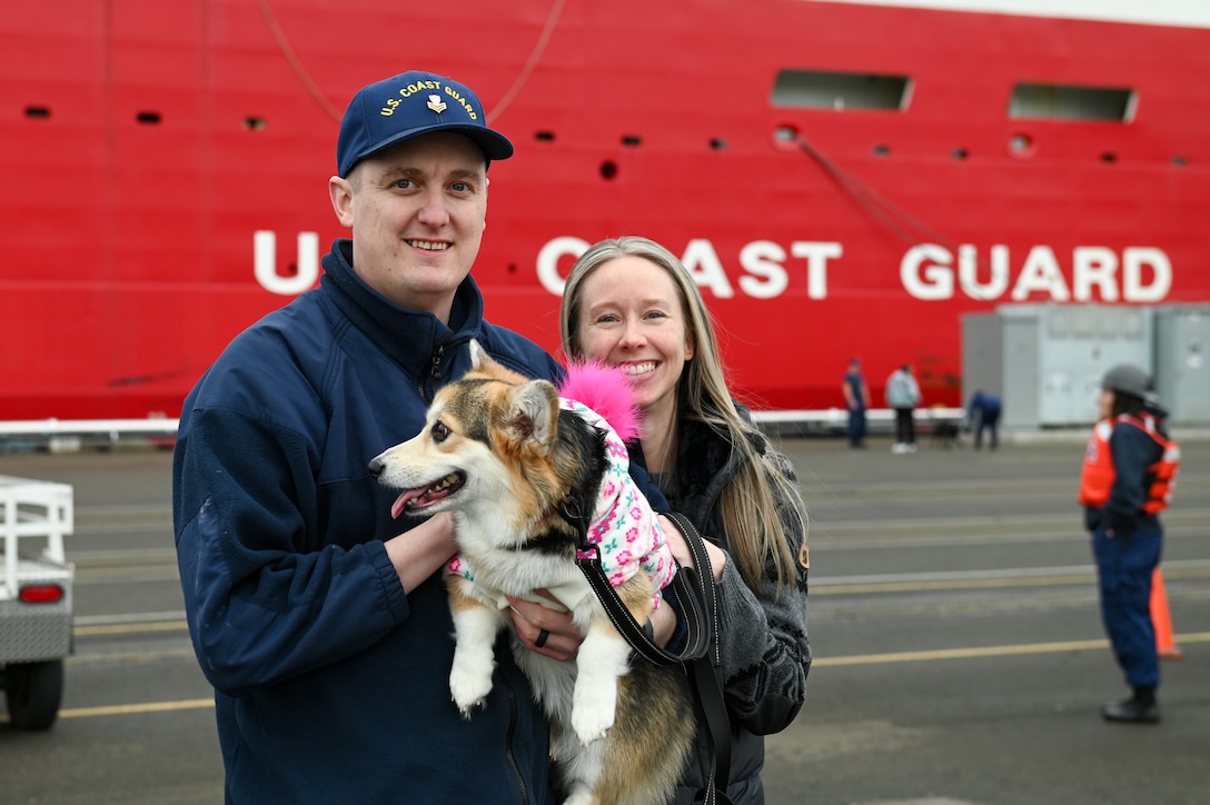 A member of the Coast Guard Cutter Healy (WAGB 20) embraces his family member on the pier at Base Seattle after a multi-month deployment, Dec. 12, 2024. The Healy is one of two icebreakers stationed in Seattle and is the only military ship dedicated to conducting research in the Arctic. (U.S. Coast Guard photo by Petty Officer 3rd Class Annika Hirschler)