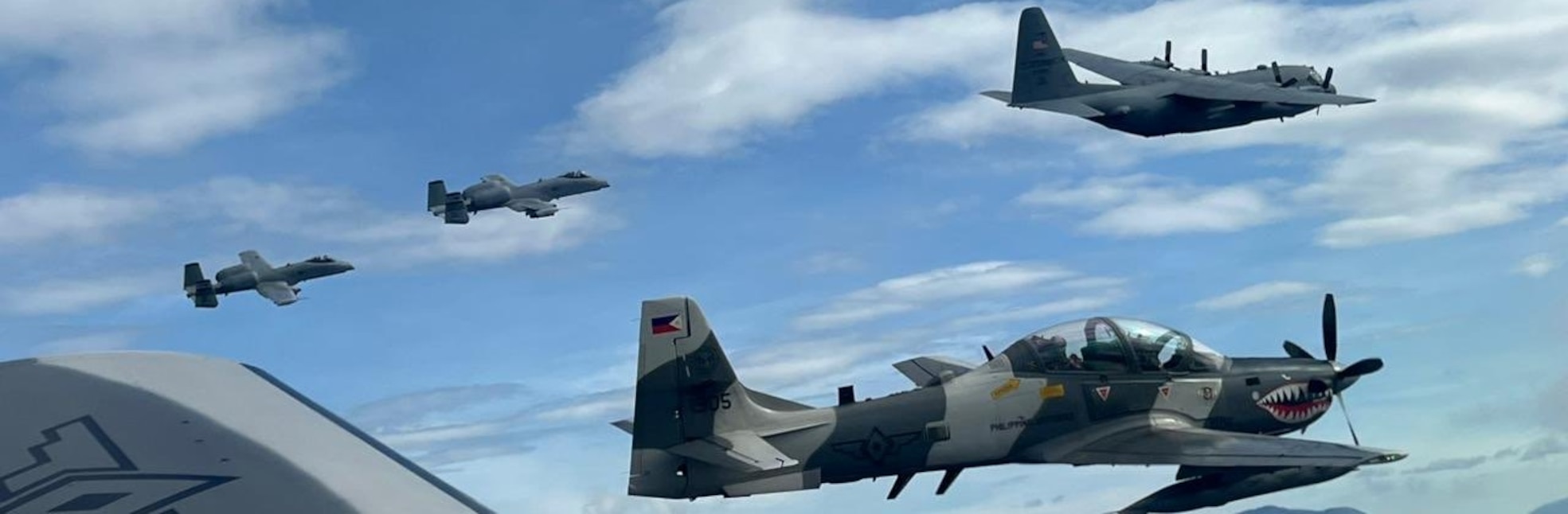 A Philippine Air Force A-29 Super Tucano, a Missouri Air National Guard C-130 H2 Hercules, and two 25th Fighter Squadron A-10 Thunderbolt IIs conduct a formation flight over the Philippine Sea, Dec. 12, 2024.