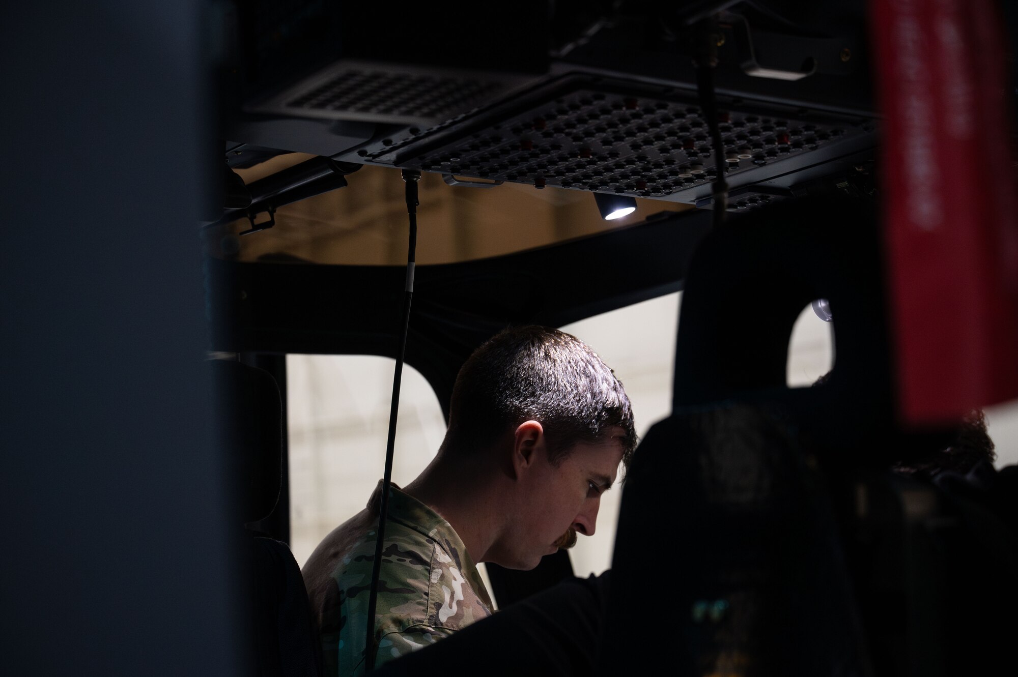 a man sit on a flight deck of a helicopter