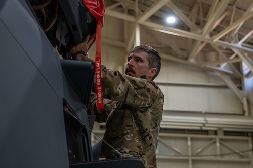 a man checks a helicopter pre-flight