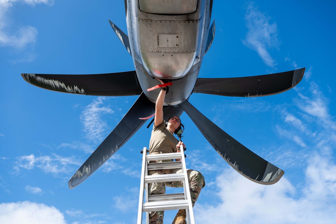 Airman repairing engine
