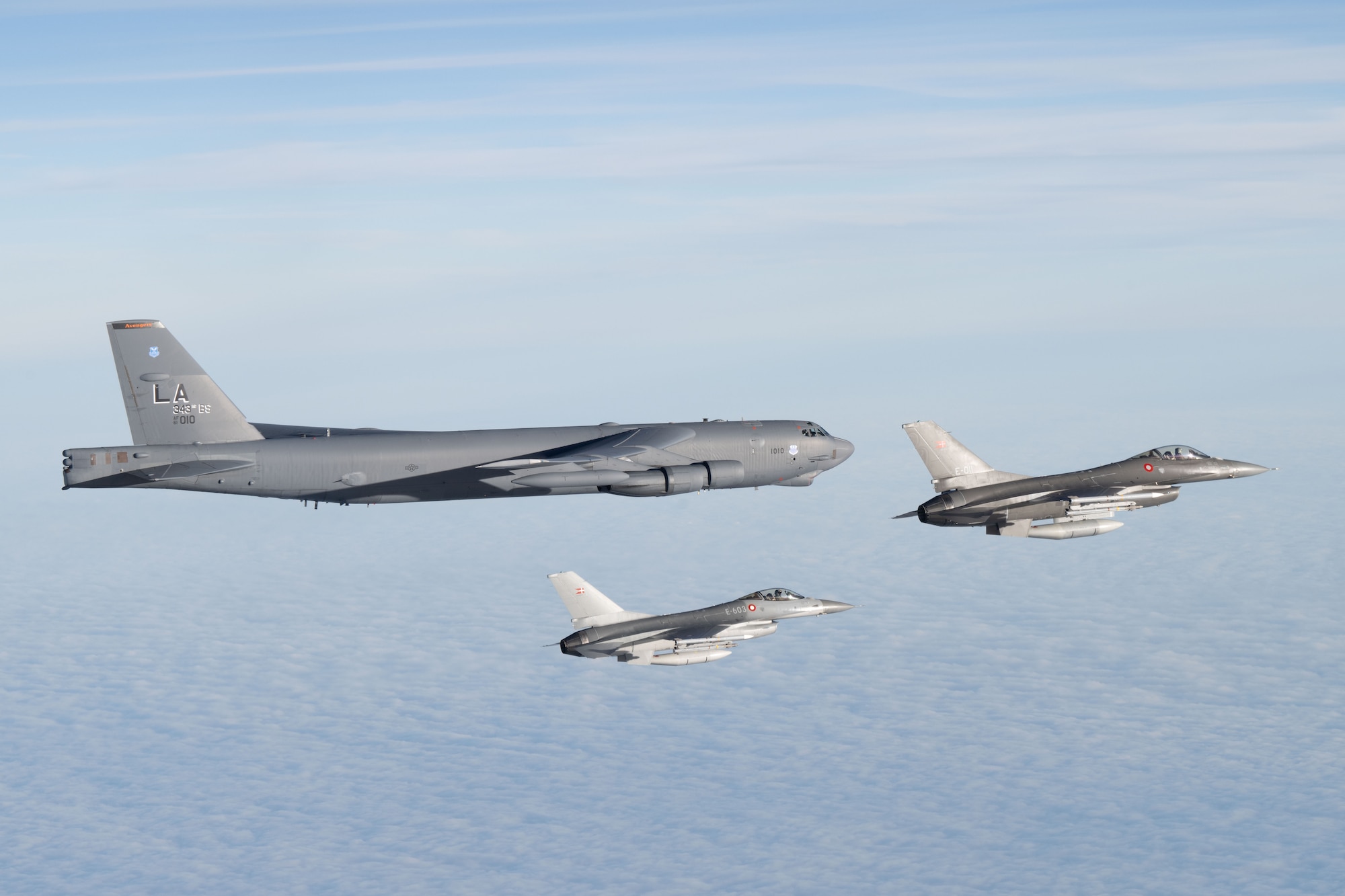 A U.S. Air Force B-52H Stratofortress assigned to the 20th Expeditionary Bomb Squadron is escorted by two Royal Danish Air Force F-16 Fighting Falcons above the Baltic Sea during Bomber Task Force 25-1, Nov. 15, 2024. We are stronger together. BTF 25-1 is a part of a long-term multinational training plan to maintain readiness and interoperability between NATO Allies and partner nations in the Baltic Sea region. (U.S. Air Force photo by Senior Airman Jacob Cabanero)