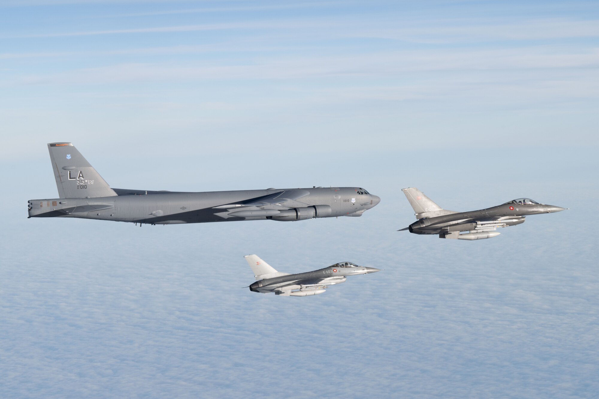 A U.S. Air Force B-52H Stratofortress assigned to the 20th Expeditionary Bomb Squadron is escorted by two Royal Danish Air Force F-16 Fighting Falcons above the Baltic Sea during Bomber Task Force 25-1, Nov. 15, 2024. We are stronger together. BTF 25-1 is a part of a long-term multinational training plan to maintain readiness and interoperability between NATO Allies and partner nations in the Baltic Sea region. (U.S. Air Force photo by Senior Airman Jacob Cabanero)