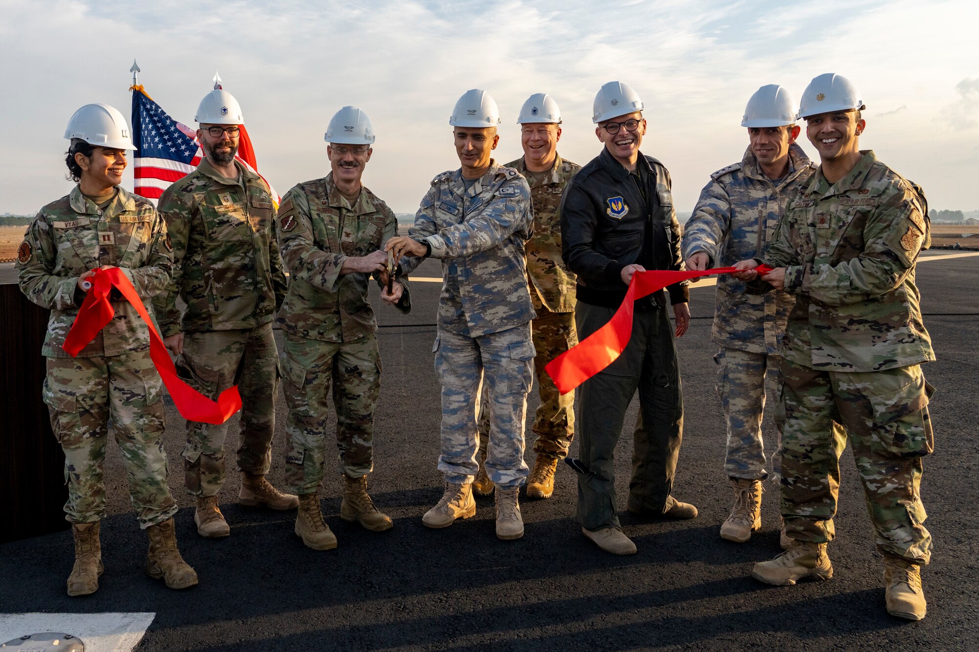 Members of the 39th Air Base Wing and the 10th Main Jet Base Command, cut a ribbon during a ceremony to mark the completion of the airfield overrun extension project at Incirlik Air Base, Türkiye, Dec. 12, 2024. Construction began in September 2023 and was completed over 14 months at a cost of $2.3 million. (U.S. Air Force photo by Tech. Sgt. Dhruv Gopinath)