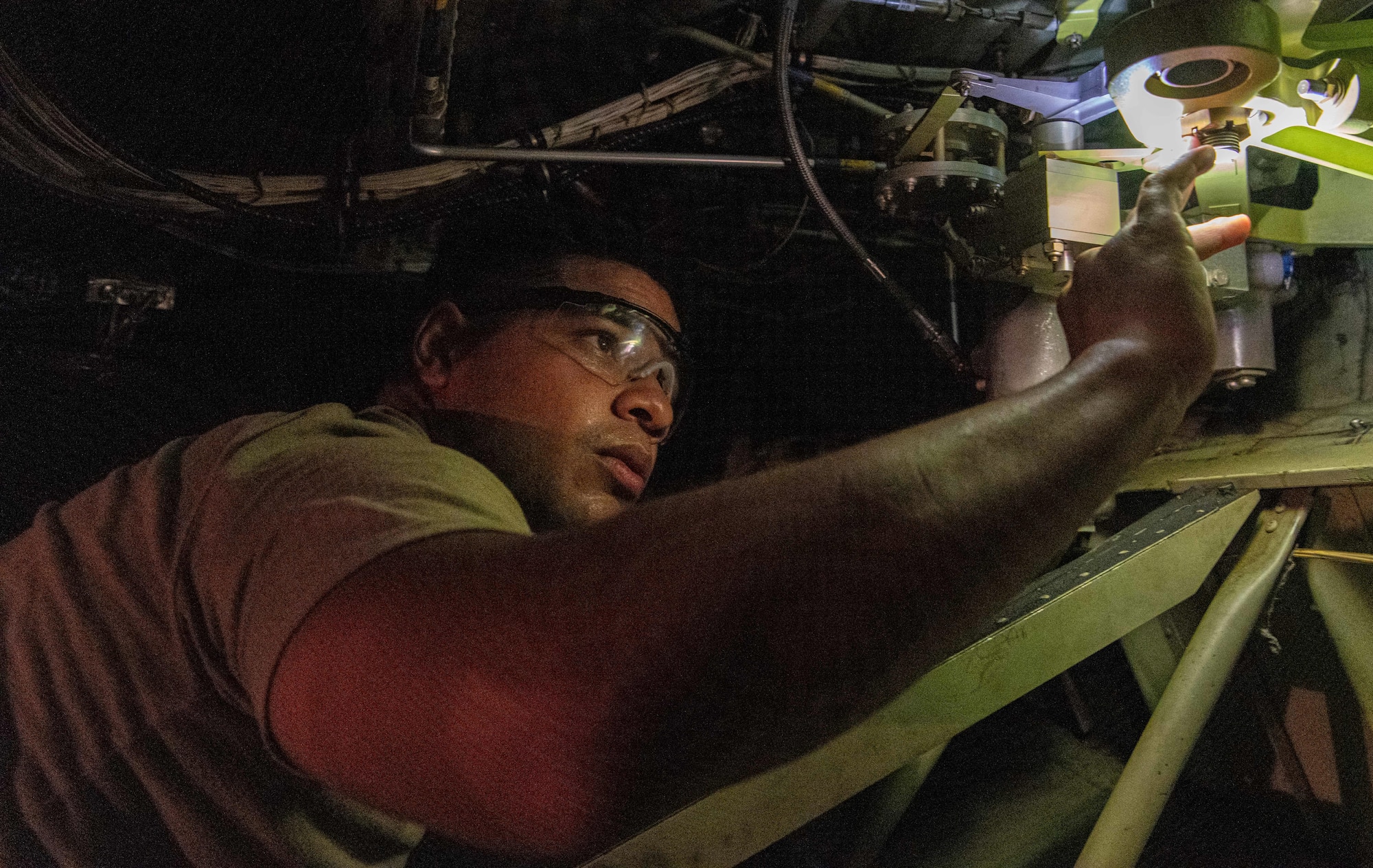 U.S. Air Force and Royal Australian Air Force maintainers perform maintenance on a C-130J Super Hercules during Operation Christmas Drop 2024 at Andersen Air Force Base, Guam. The maintainers worked around the clock to ensure aircraft were mission-ready for humanitarian airdrop operations delivering essential supplies to remote Pacific island communities.