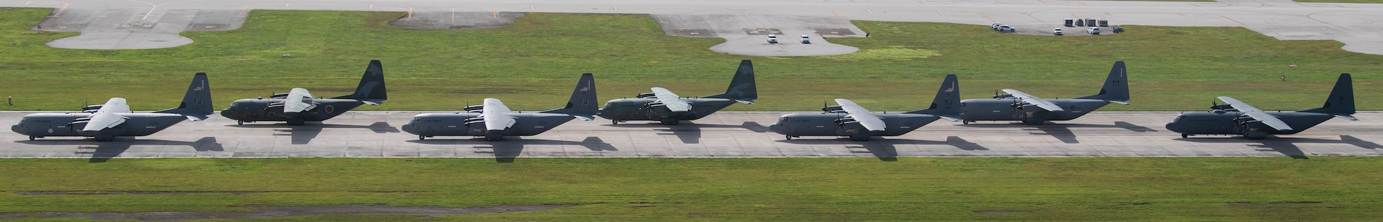 Seven planes stand in a line.