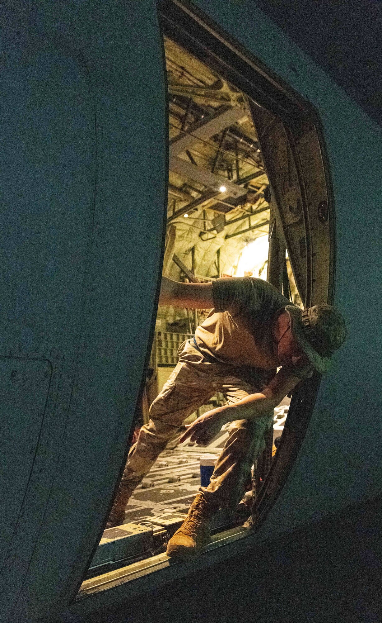 U.S. Air Force and Royal Australian Air Force maintainers perform nighttime maintenance on a C-130J Super Hercules during Operation Christmas Drop 2024 at Andersen Air Force Base, Guam. The maintainers worked around the clock to ensure aircraft were mission-ready for humanitarian airdrop operations delivering essential supplies to remote Pacific island communities.
