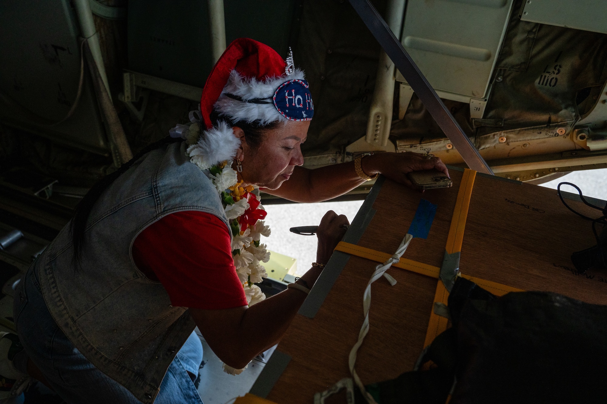 Airmen, family members, and international partners gathered at Andersen Air Force Base, Guam, December 12, 2024, to honor U.S. Air Force Senior Airman Jeremy Jutba-Hake, who passed away in 2015 while supporting Operation Christmas Drop. A commemorative aid bundle signed by attendees was later delivered to remote Pacific islands as part of the annual humanitarian mission.