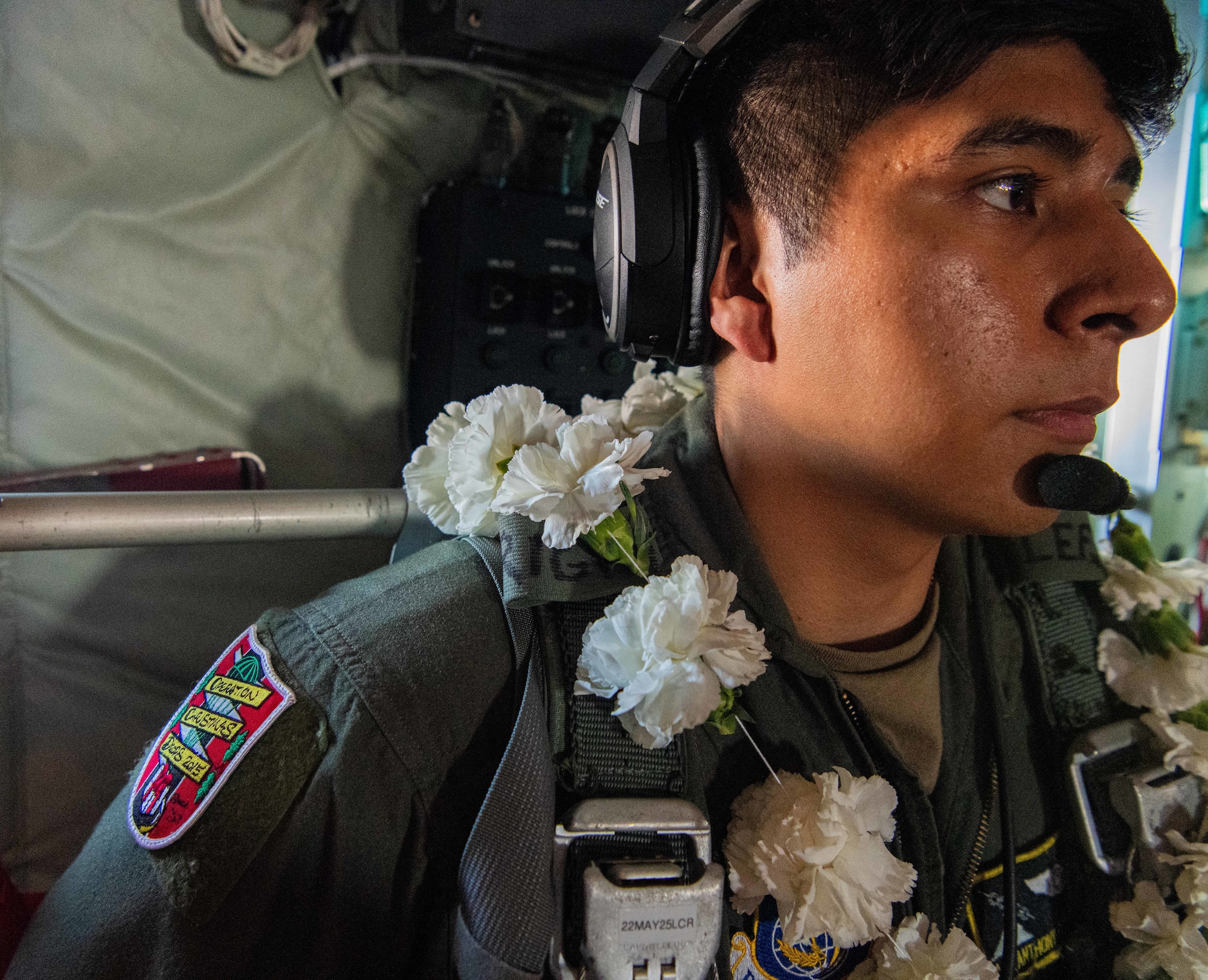 Airmen, family members, and international partners gathered at Andersen Air Force Base, Guam, December 12, 2024, to honor U.S. Air Force Senior Airman Jeremy Jutba-Hake, who passed away in 2015 while supporting Operation Christmas Drop. A commemorative aid bundle signed by attendees was later delivered to remote Pacific islands as part of the annual humanitarian mission. (U.S. Air Force photo by [Photographer's Name])