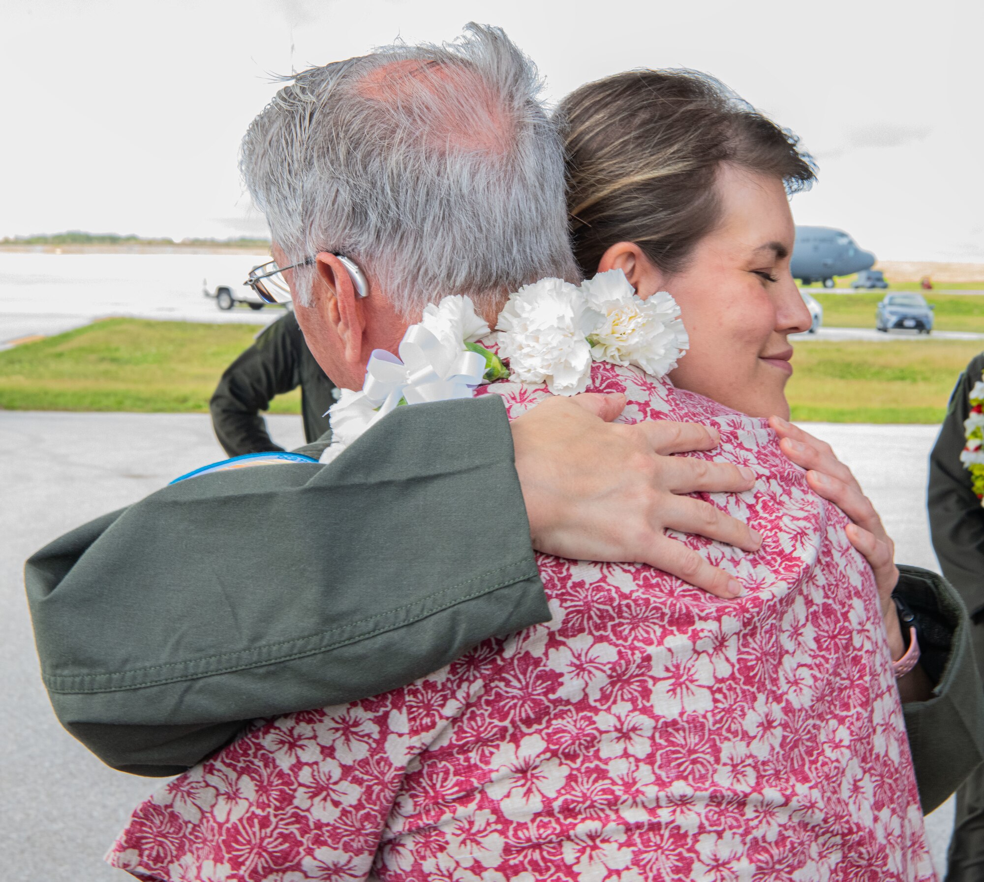 Airmen, family members, and international partners gathered at Andersen Air Force Base, Guam, December 12, 2024, to honor U.S. Air Force Senior Airman Jeremy Jutba-Hake, who passed away in 2015 while supporting Operation Christmas Drop. A commemorative aid bundle signed by attendees was later delivered to remote Pacific islands as part of the annual humanitarian mission. (U.S. Air Force photo by [Photographer's Name])