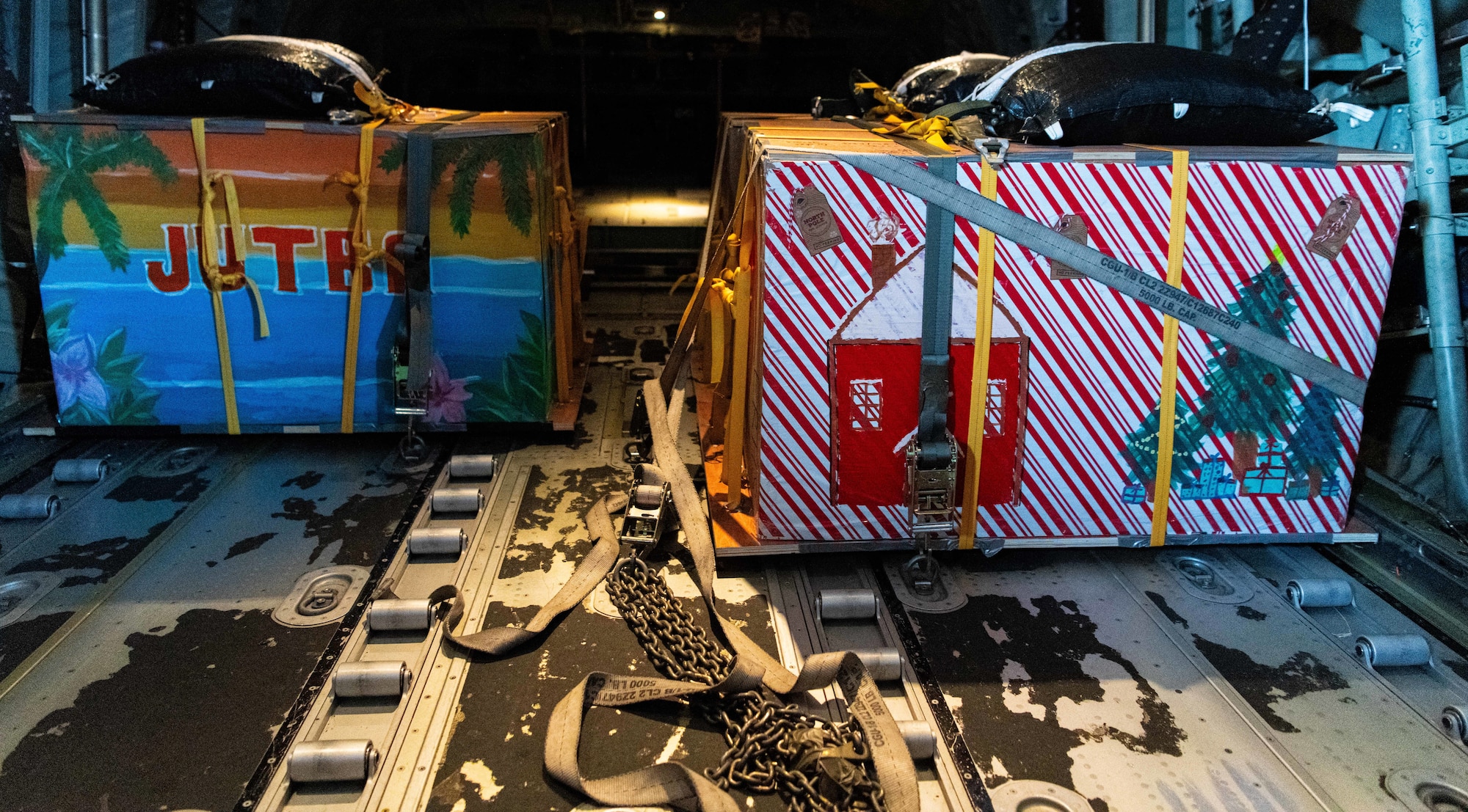 Airmen, family members, and international partners gathered at Andersen Air Force Base, Guam, December 12, 2024, to honor U.S. Air Force Senior Airman Jeremy Jutba-Hake, who passed away in 2015 while supporting Operation Christmas Drop. A commemorative aid bundle signed by attendees was later delivered to remote Pacific islands as part of the annual humanitarian mission. (U.S. Air Force photo by [Photographer's Name])