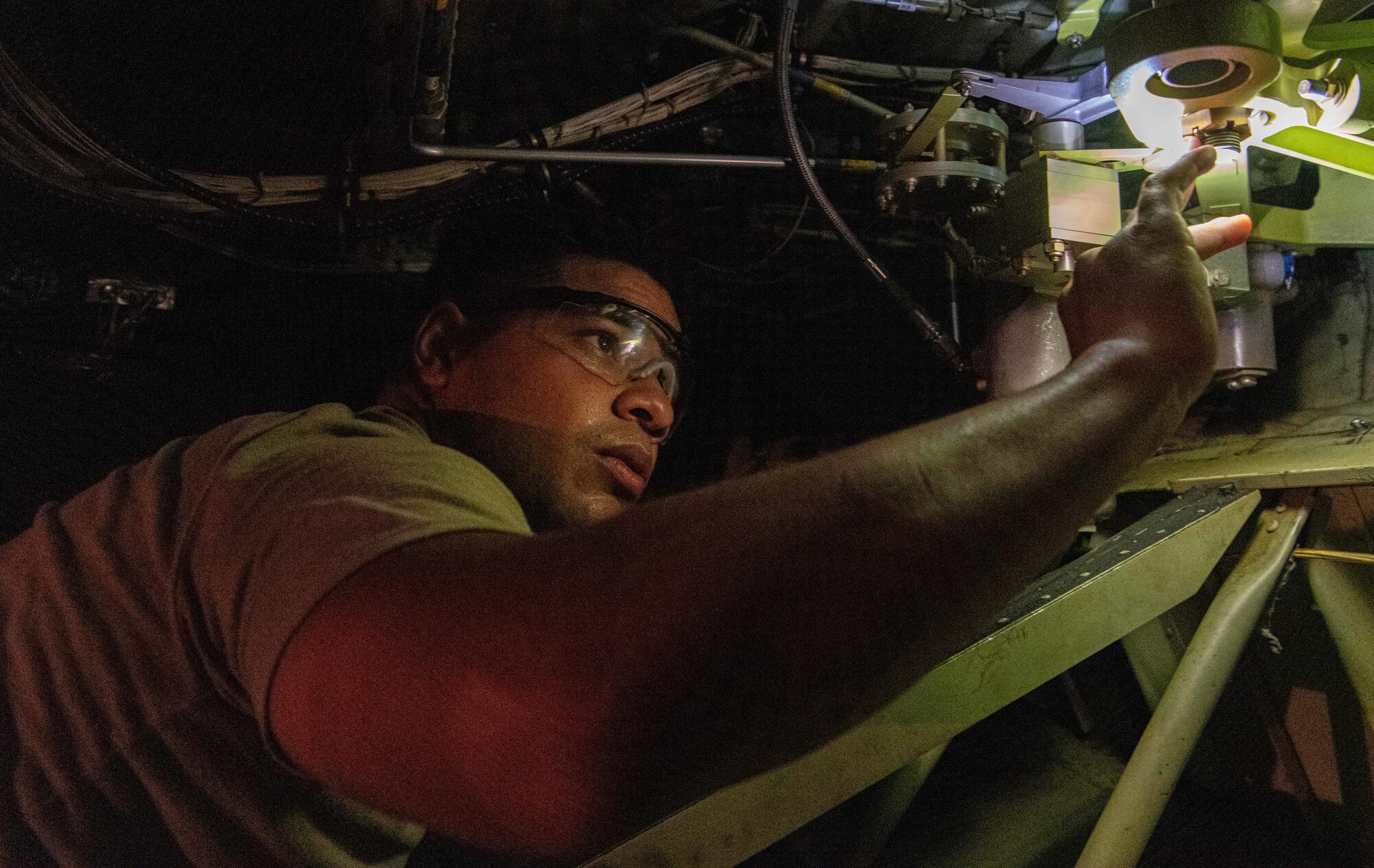 U.S. Air Force and Royal Australian Air Force maintainers perform maintenance on a C-130J Super Hercules during Operation Christmas Drop 2024 at Andersen Air Force Base, Guam. The maintainers worked around the clock to ensure aircraft were mission-ready for humanitarian airdrop operations delivering essential supplies to remote Pacific island communities.