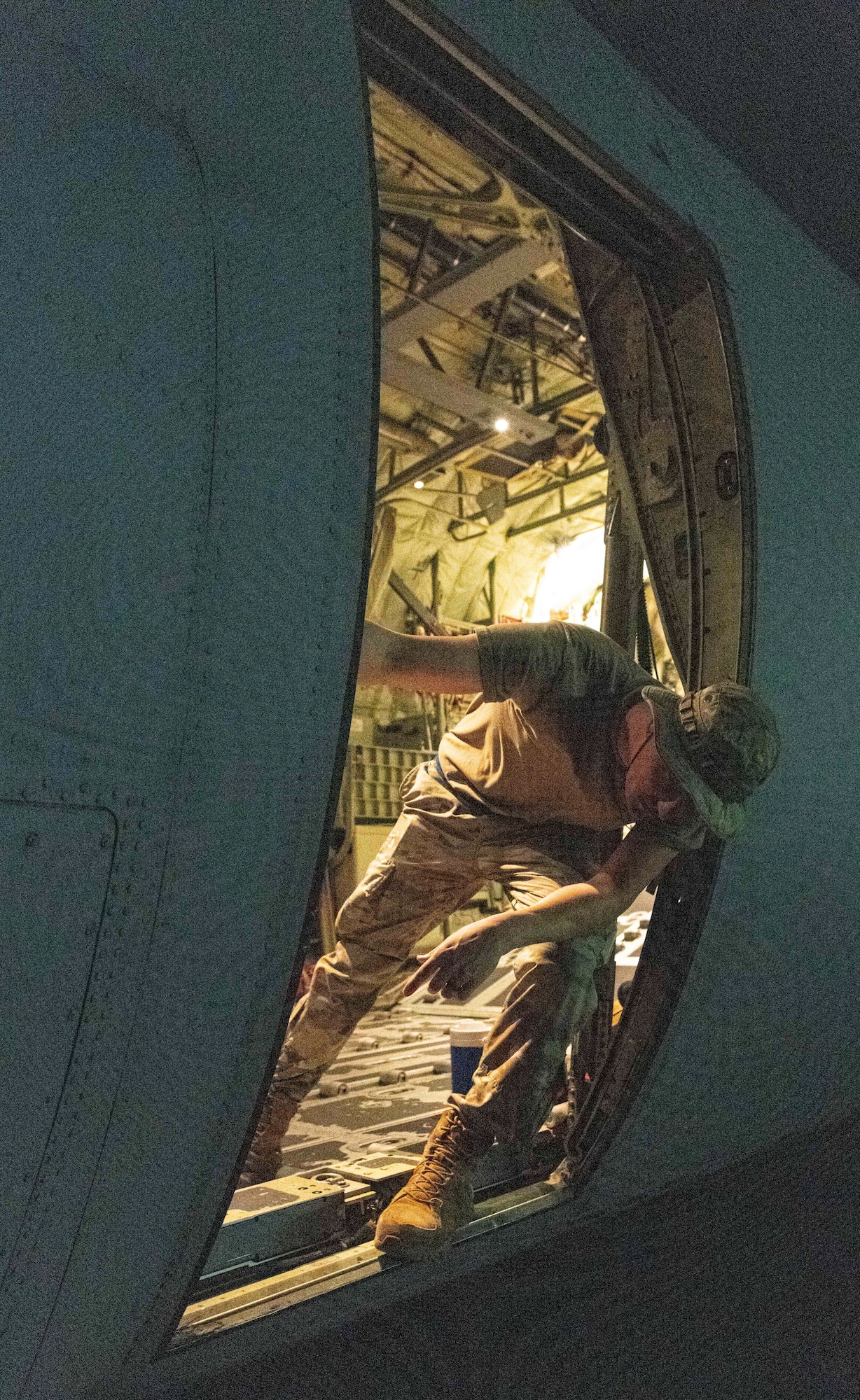 U.S. Air Force and Royal Australian Air Force maintainers perform nighttime maintenance on a C-130J Super Hercules during Operation Christmas Drop 2024 at Andersen Air Force Base, Guam. The maintainers worked around the clock to ensure aircraft were mission-ready for humanitarian airdrop operations delivering essential supplies to remote Pacific island communities.
