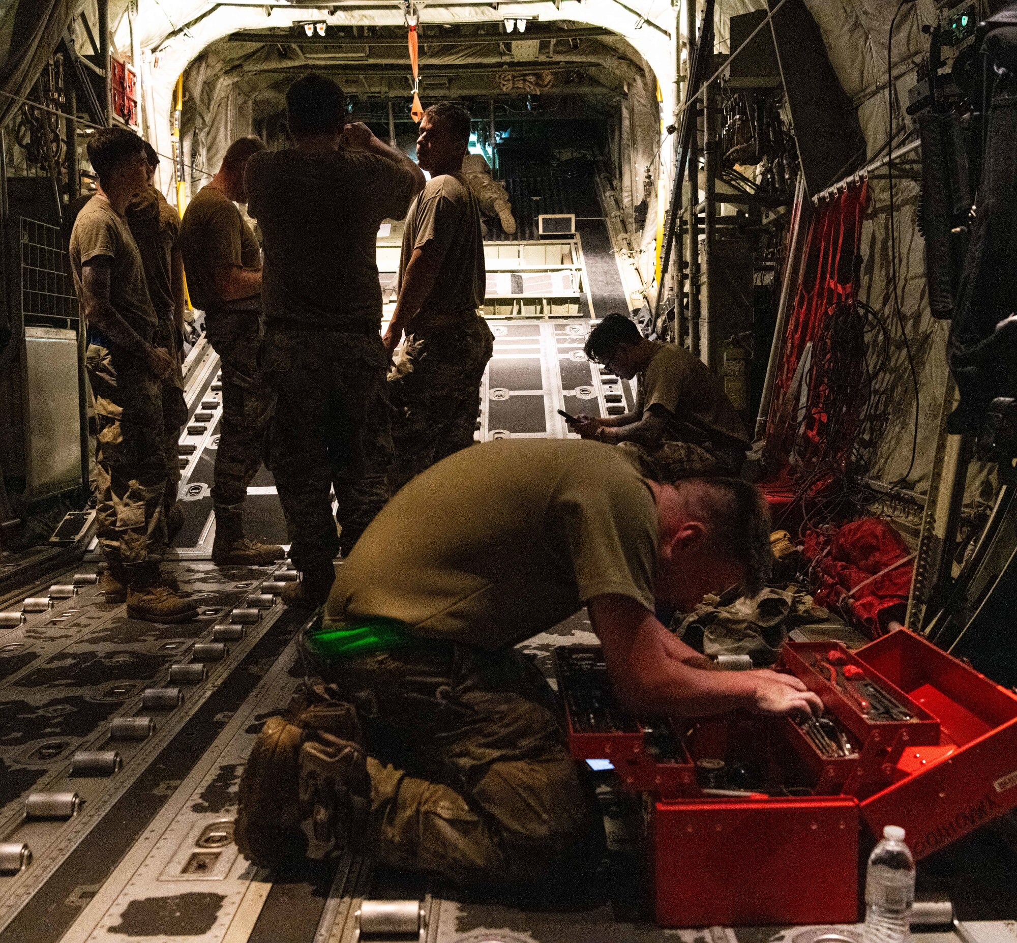 U.S. Air Force and Royal Australian Air Force maintainers perform nighttime maintenance on a C-130J Super Hercules during Operation Christmas Drop 2024 at Andersen Air Force Base, Guam. The maintainers worked around the clock to ensure aircraft were mission-ready for humanitarian airdrop operations delivering essential supplies to remote Pacific island communities.