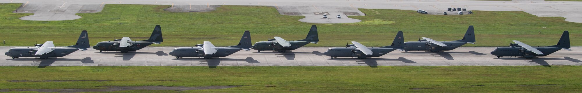 Seven planes stand in a line.