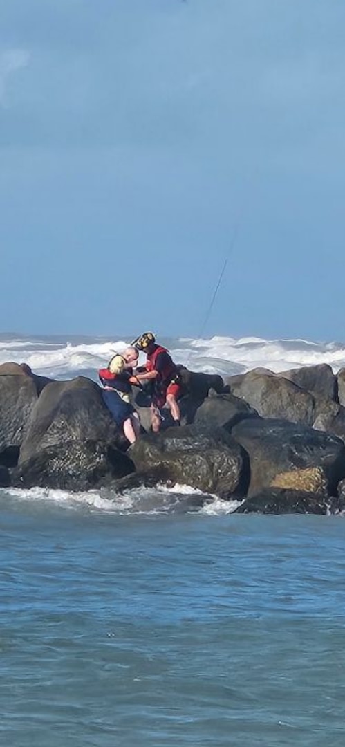 A Coast Guard Air Station Miami MH-65 aviation survival technician rescues a man stranded on a jetty in the vicinity of St Lucie Inlet, Dec. 15, 2024. The aircrew brought the man to Stuart Airport with no medical concerns. (U.S. Coast Guard photo by Station Fort Pierce)