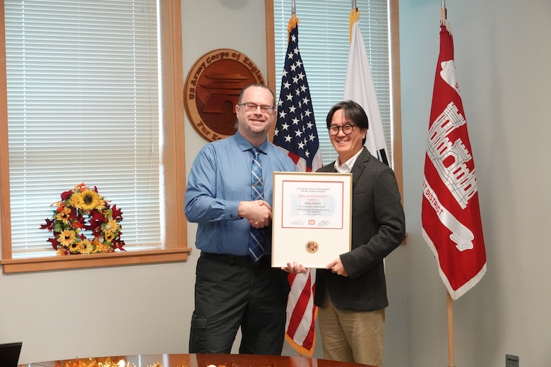 Seung Ji, Deputy Chief of Construction, U.S. Army Corps of Engineers – Far East District, who has been with the district for 10 years accepts his certificate for completing the USACE Leadership Development Program (ULDP) Level 3 on Dec. 5, 2024, at Camp Humphreys, South Korea. He describes the program as being “a lighthouse” to guide him in his leadership journey. Daniel Foltz, Deputy Chief of Programs & Project Management, USACE-FED, presents Ji with his certificate. (U.S. Army photo by Kyong Il Yo)