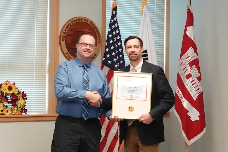 Christopher Carson, project manager, U.S. Army Corps of Engineers – Far East District, whose portfolio encompasses major projects on Osan Air Force Base, accepts his certificate for completing the USACE Leadership Development Program (ULDP) Level 3 on Dec. 5, 2024, at Camp Humphreys, South Korea. Daniel Foltz, Deputy Chief of Programs & Project Management, USACE-FED, presents Ji with his certificate. (U.S. Army photo by Kyong Il Yo)