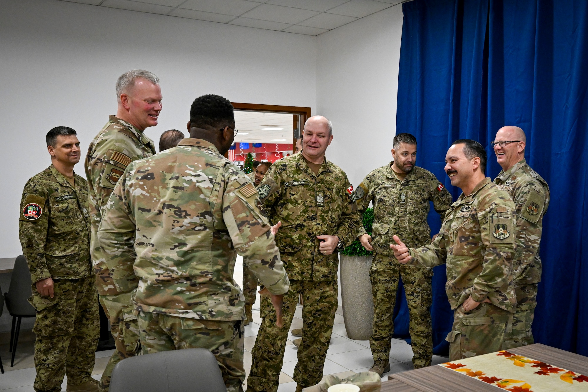 Canadian Armed Forces military members and U.S. Air Force military members greet one another .
