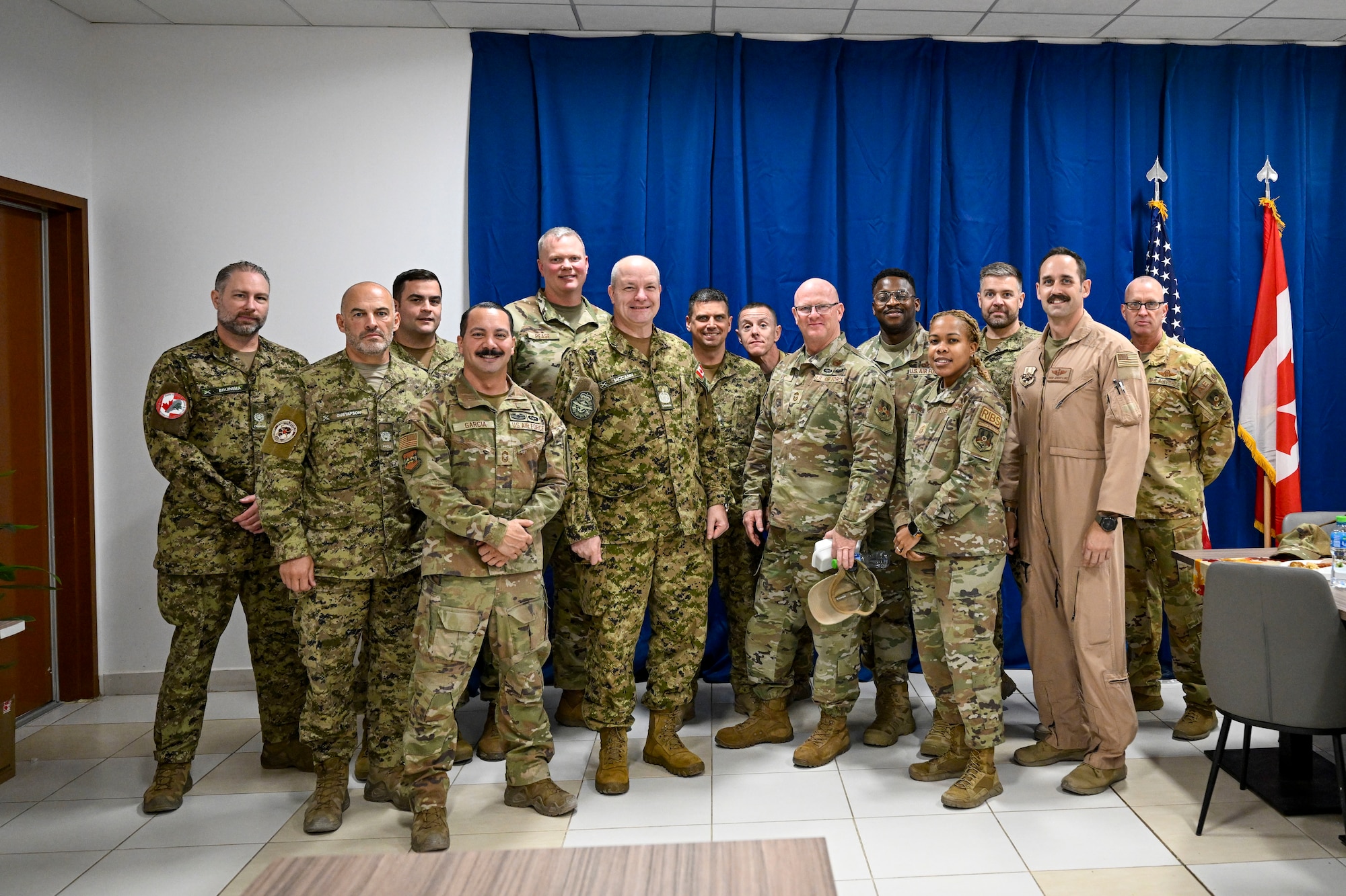 Canadian Armed Forces military members and U.S. Air Force military members pose for a photo.