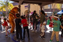 Families and volunteers dance to music provided at the Holiday Express event at Marine Corps Recruit Depot San Diego, California, Dec. 7, 2024. The Holiday Express is an annual event held at the Depot to bring holiday cheer to Marines, civilian employees and their families with crafts, music, opportunity drawings and more. (U.S. Marine Corps photo by Cpl. Alexander O. Devereux)