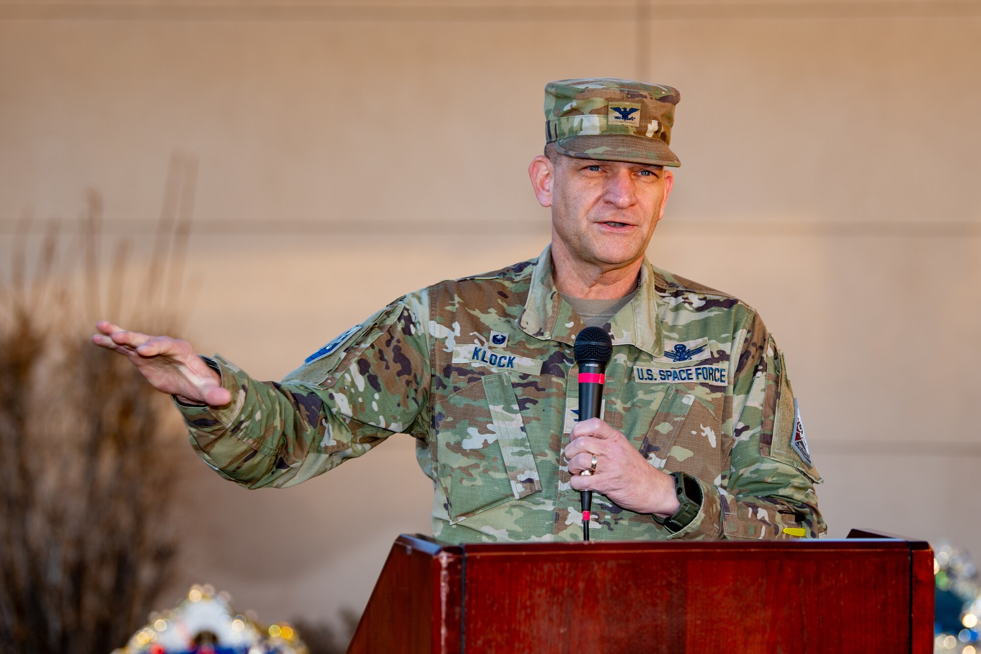 Col. Klock stand behind a podium giving remarks.