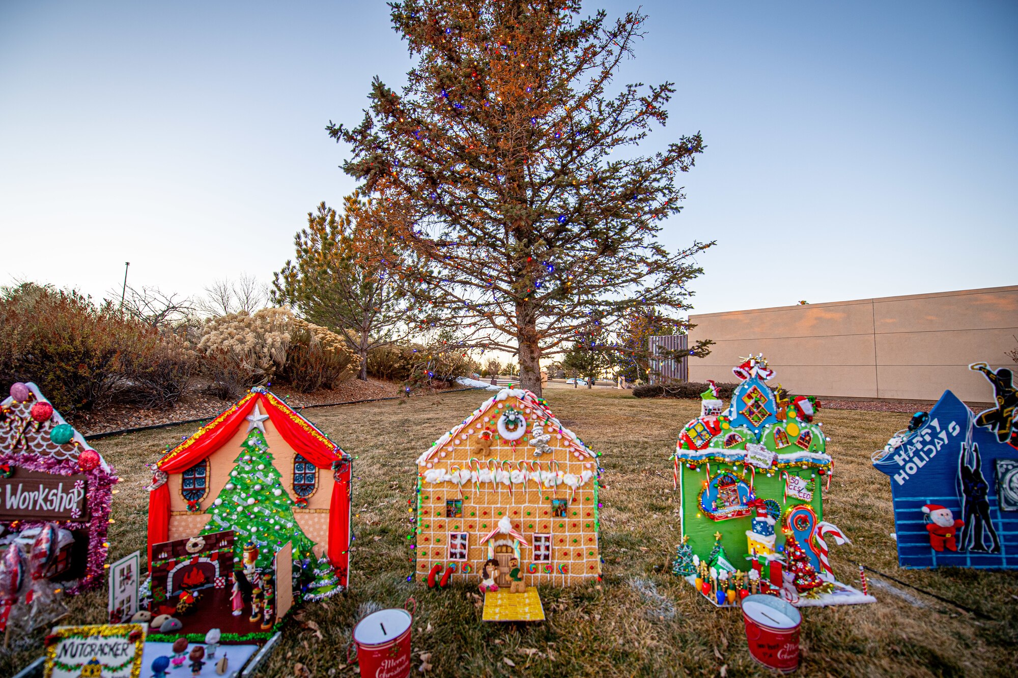 Make-shift gingerbread houses stand lined up outside for the Christmas tree lighting event.