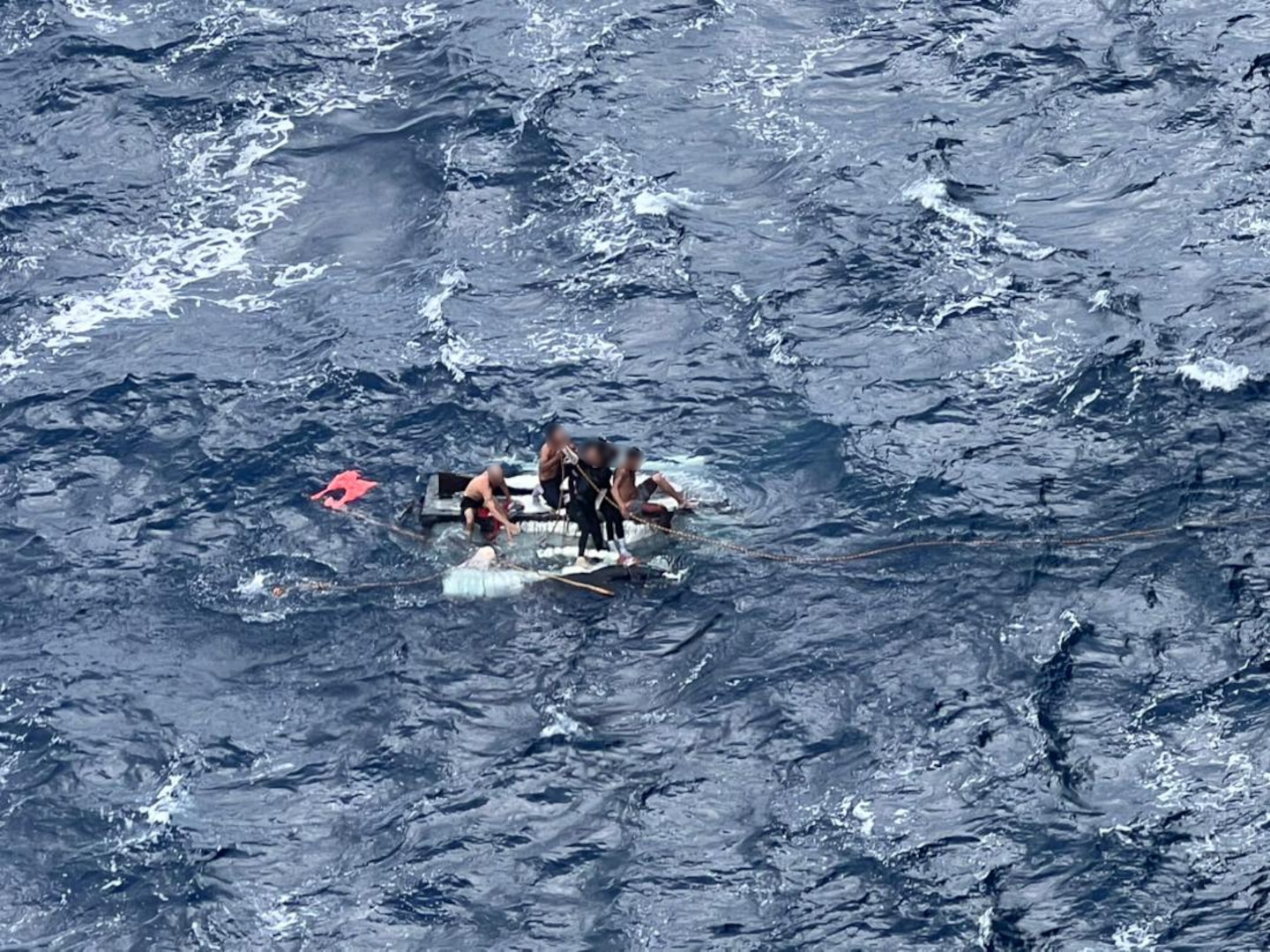 Migrants on a disabled makeshift vessel in the Florida Straits, Dec. 15, 2024. The migrants were rescued and transferred to a Coast Guard cutter for disposition. (Courtesy photo)